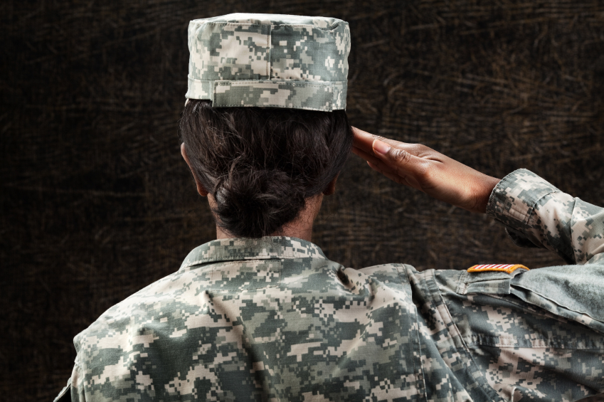 woman in military uniform saluting from behind
