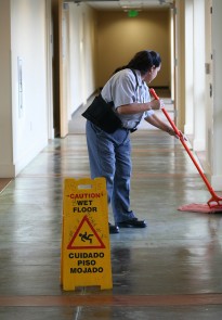 A photo of a janitor mopping