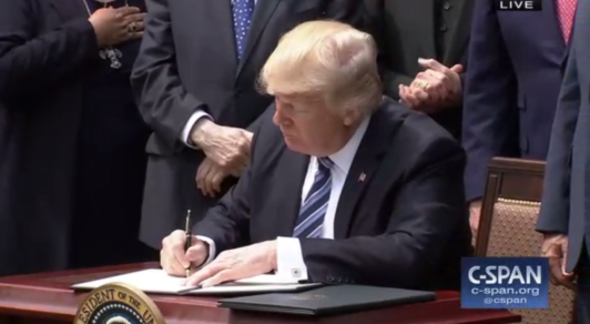 Trump signing a document
