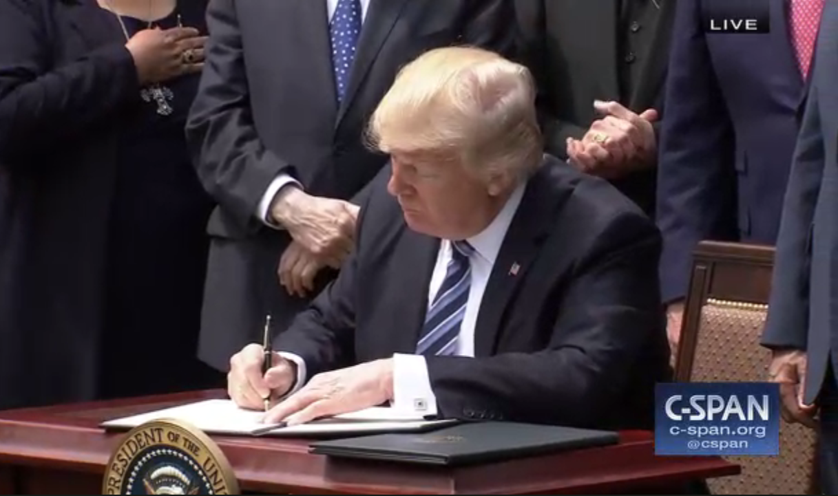 Trump signing a document