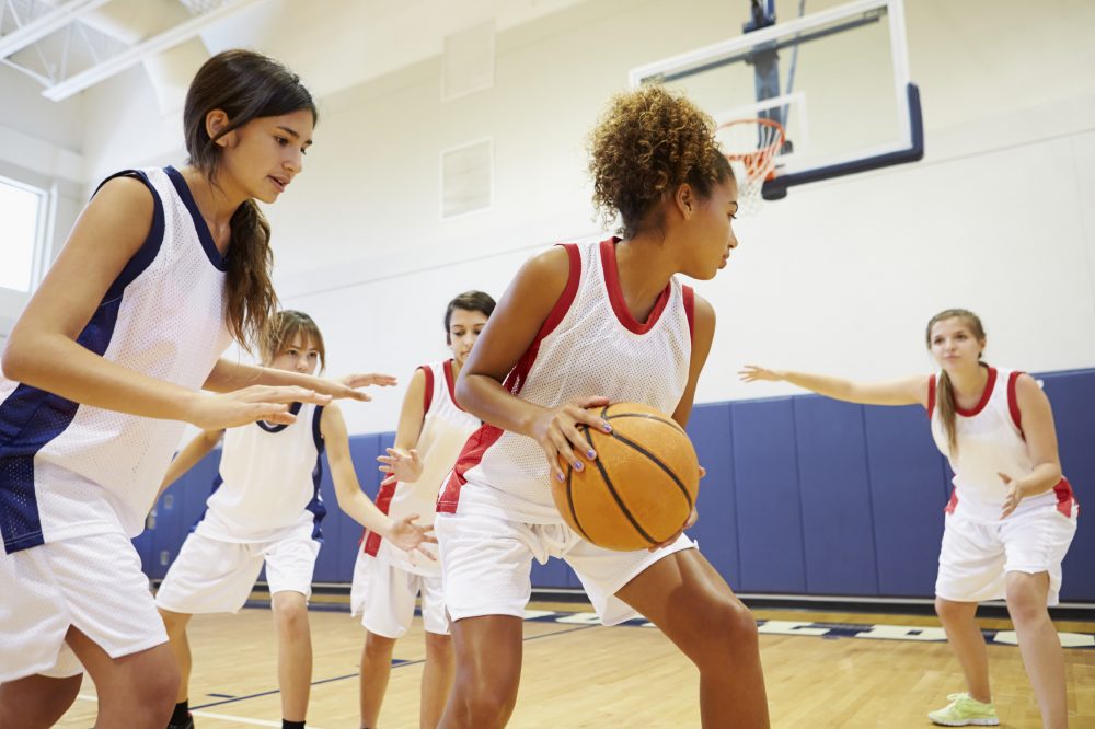 Female High School Basketball Team Playing Game