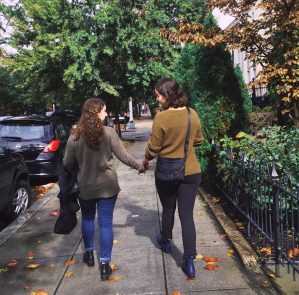 Estelle and her partner walking down the street