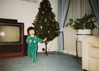 Me hanging out with the Christmas tree we put up every year even though we didn’t celebrate and never had presents to put underneath it. 