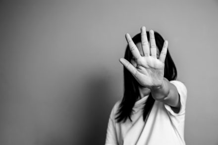 Asian woman raised her hand for dissuade with copy space, black and white color