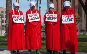 Protesters wearing Handmaid's Tale outfits in protest of an anti-abortion bill