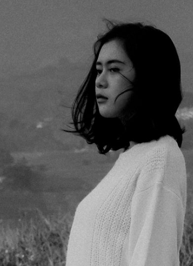 black and white image of a woman looking into the distance
